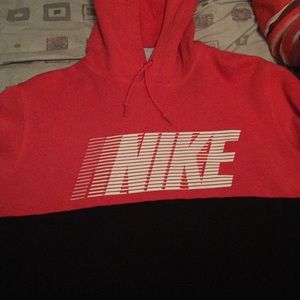 Half black half red Nike hoodie.
